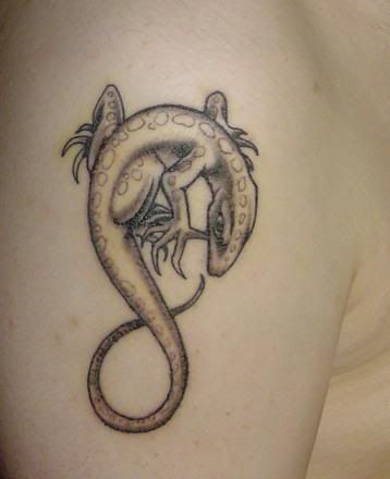 Here comes a simple but elegant reptile tattoo of a lizard. Isn't it nice?