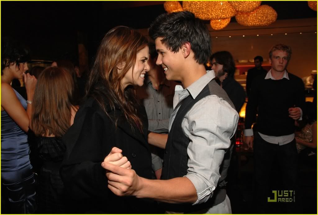 http://i232.photobucket.com/albums/ee236/shadowma1771/Twilight/nikki-reed-taylor-lautner-salute-5.jpg